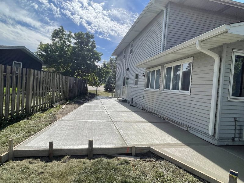 Backyard concrete patio with broom finish